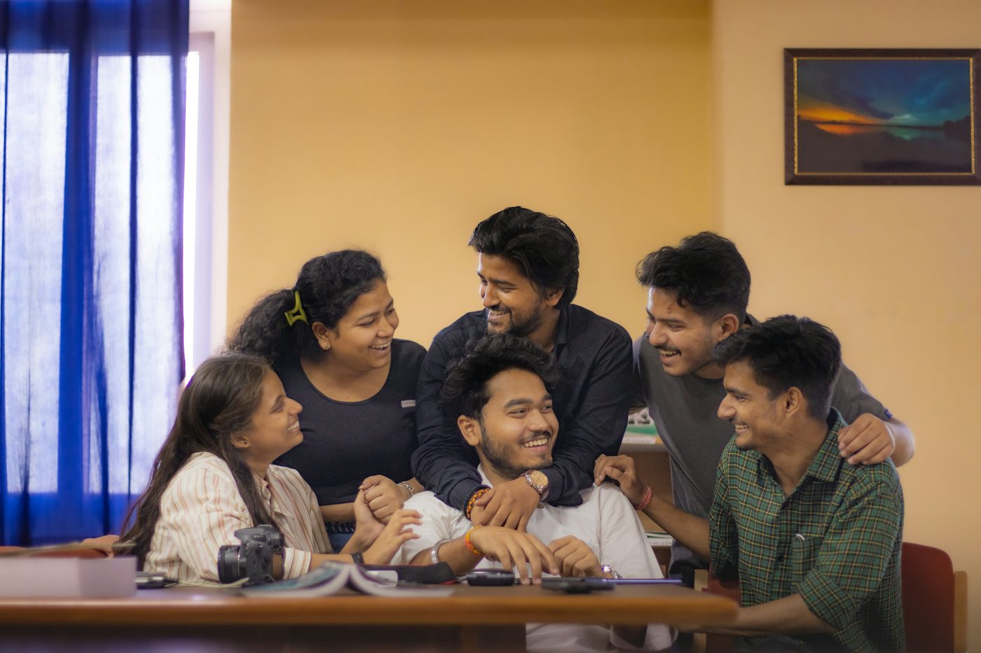 College students studying and laughing together around a table